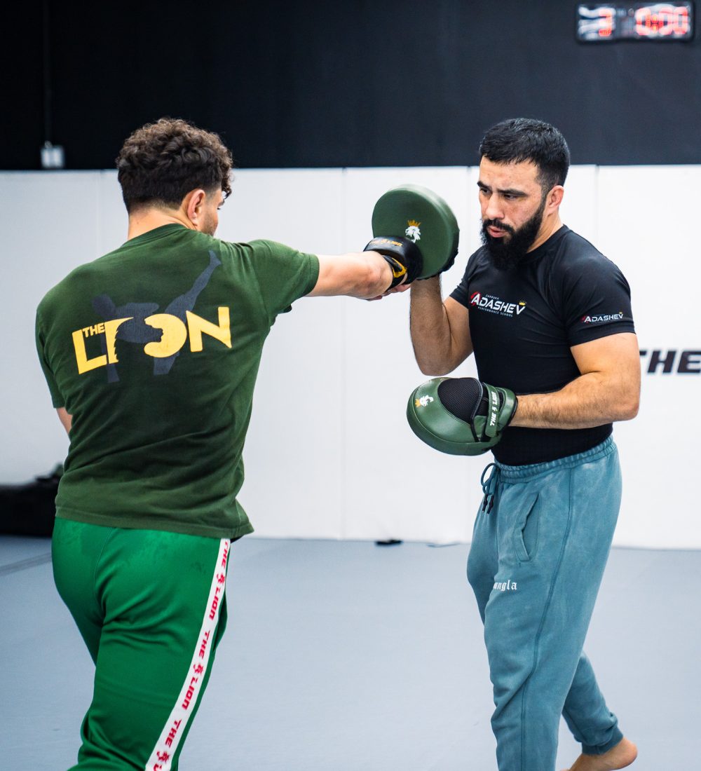 Coach Zarrukh holding pads