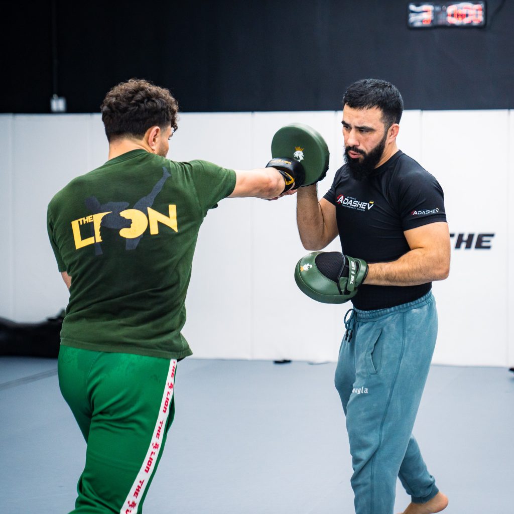 Coach Zarrukh holding pads